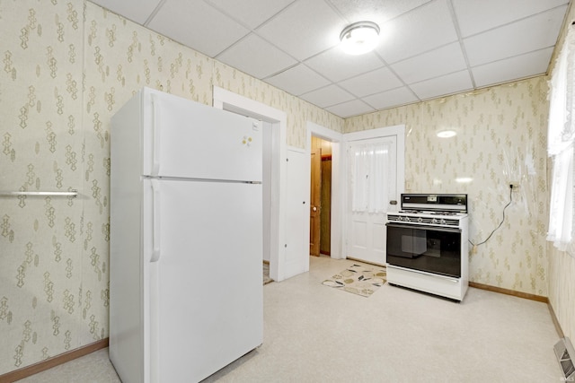 1202 S Van Buren St, Auburn, IN 46706 - kitchen with white appliances, a paneled ceiling, baseboards, and wallpapered walls