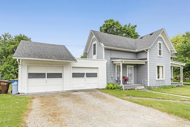 1202 S Van Buren St, Auburn, IN 46706 - view of front of home featuring driveway, a garage, a shingled roof, a front yard, and covered porch