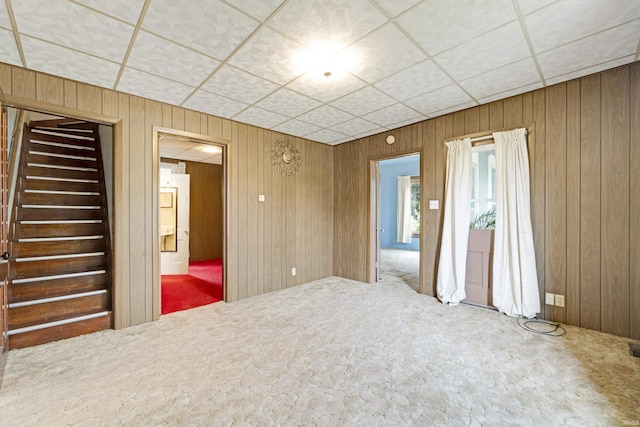 1202 S Van Buren St, Auburn, IN 46706 - unfurnished room featuring carpet, wood walls, and stairs