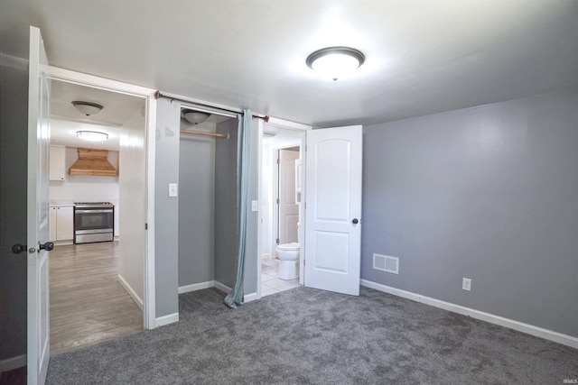 52589 Lilac Rd, South Bend, IN 46628 - unfurnished bedroom featuring baseboards, carpet floors, and a closet