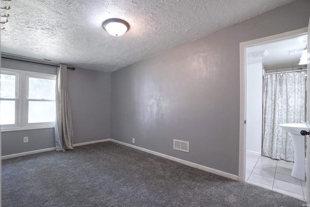 52589 Lilac Rd, South Bend, IN 46628 - carpeted empty room featuring a textured ceiling and baseboards