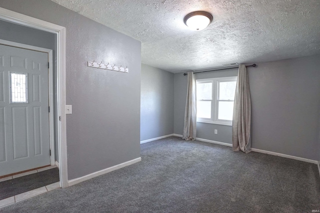 52589 Lilac Rd, South Bend, IN 46628 - spare room featuring a textured ceiling, carpet flooring, and baseboards