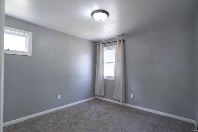 52589 Lilac Rd, South Bend, IN 46628 - spare room with healthy amount of natural light, carpet, and baseboards