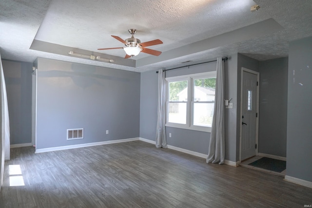 52589 Lilac Rd, South Bend, IN 46628 - unfurnished room featuring a textured ceiling, wood finished floors, a tray ceiling, a ceiling fan, and baseboards