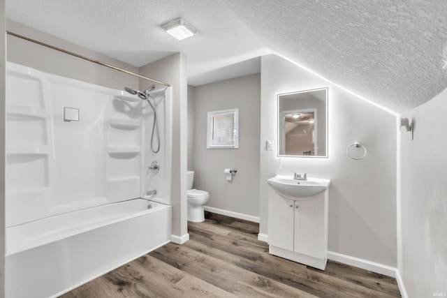 3709 Shady Ct, Fort Wayne, IN 46807 - bathroom featuring a textured ceiling, toilet, vanity, lofted ceiling, and wood finished floors