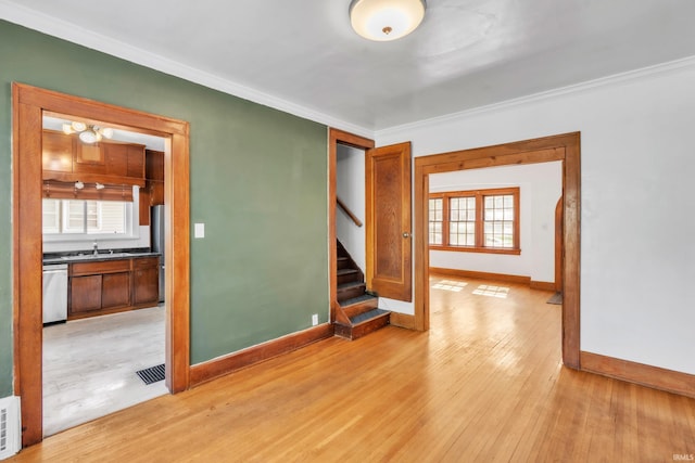 3709 Shady Ct, Fort Wayne, IN 46807 - unfurnished room featuring a sink, baseboards, stairs, plenty of natural light, and crown molding
