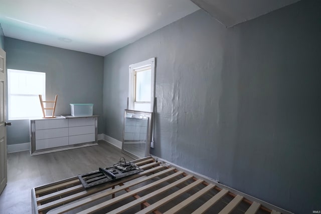 2117 Linden Ave, South Bend, IN 46628 - unfurnished bedroom with multiple windows, wood finished floors, and baseboards