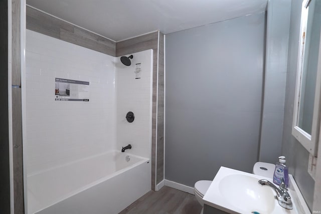 2117 Linden Ave, South Bend, IN 46628 - bathroom with wood finished floors, toilet, bathing tub / shower combination, vanity, and baseboards