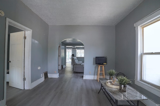 2117 Linden Ave, South Bend, IN 46628 - hall featuring arched walkways, wood finished floors, a textured ceiling, and baseboards
