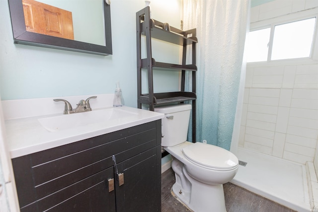 53140 Bowercrest Ct, South Bend, IN 46635 - bathroom with toilet, vanity, a tile shower, and wood finished floors