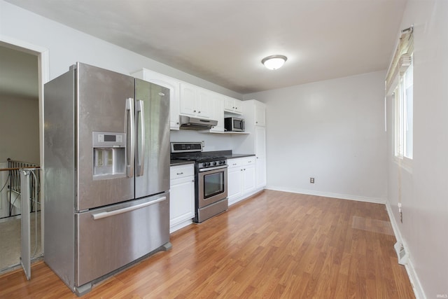 53140 Bowercrest Ct, South Bend, IN 46635 - kitchen with appliances with stainless steel finishes, under cabinet range hood, white cabinetry, and light wood-style floors