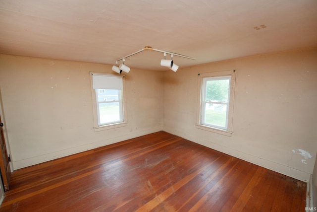 924 S Washington St, Delphi, IN 46923 - empty room with rail lighting, wood-type flooring, and baseboards