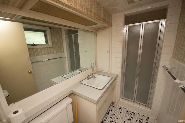 924 S Washington St, Delphi, IN 46923 - bathroom featuring tile walls, a stall shower, tile patterned flooring, vanity, and toilet