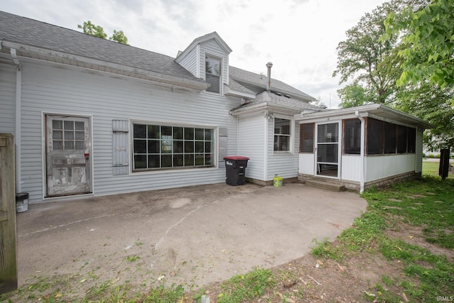 924 S Washington St, Delphi, IN 46923 - back of house with a sunroom, a patio, and roof with shingles