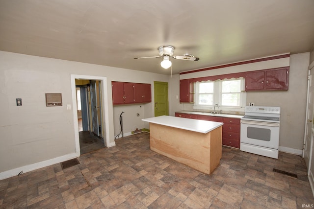 924 S Washington St, Delphi, IN 46923 - kitchen with white range with electric cooktop, ceiling fan, light countertops, a kitchen island, and baseboards