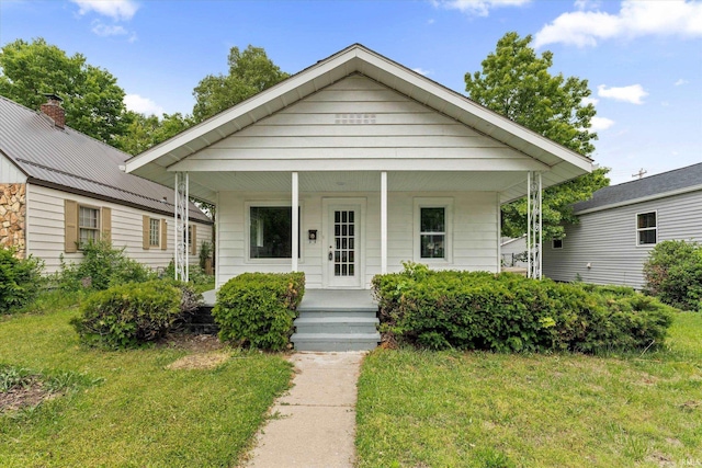 1815 E Bowman St, South Bend, IN 46613 - bungalow-style home featuring covered porch, a front yard, a chimney, and metal roof