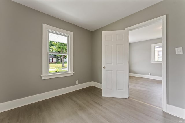 1815 E Bowman St, South Bend, IN 46613 - spare room with wood finished floors, plenty of natural light, baseboards, and lofted ceiling