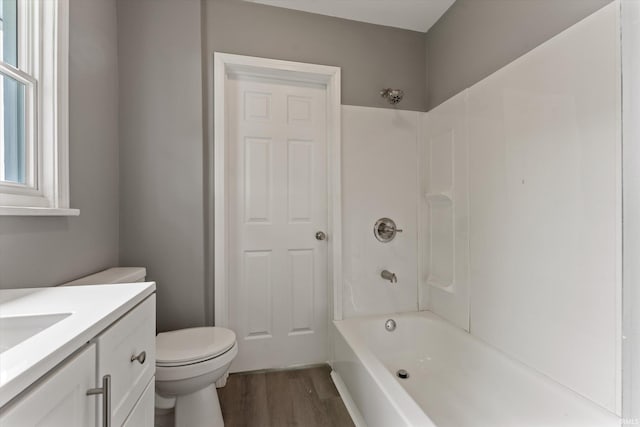 1815 E Bowman St, South Bend, IN 46613 - bathroom with wood finished floors, toilet, vanity, and shower / washtub combination