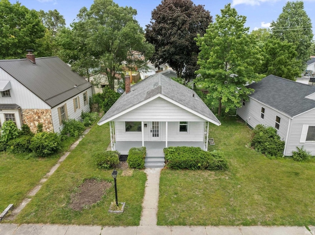 1815 E Bowman St, South Bend, IN 46613 - view of front of home featuring a porch, a chimney, a front yard, and roof with shingles