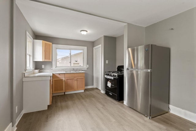 1815 E Bowman St, South Bend, IN 46613 - kitchen featuring freestanding refrigerator, gas stove, light wood finished floors, and baseboards