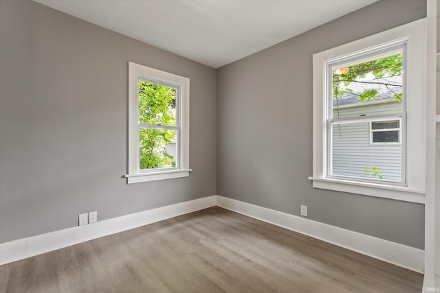 1815 E Bowman St, South Bend, IN 46613 - spare room with wood finished floors, plenty of natural light, and baseboards