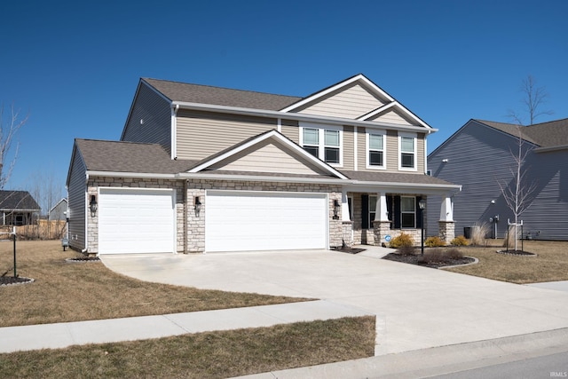 4632 Portney Pl, Fort Wayne, IN 46818 - craftsman inspired home featuring covered porch, concrete driveway, an attached garage, and stone siding