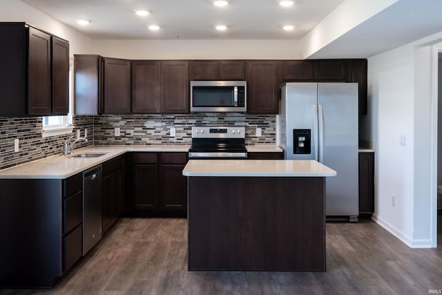 4632 Portney Pl, Fort Wayne, IN 46818 - kitchen featuring appliances with stainless steel finishes, a sink, dark wood finished floors, dark brown cabinets, and light countertops
