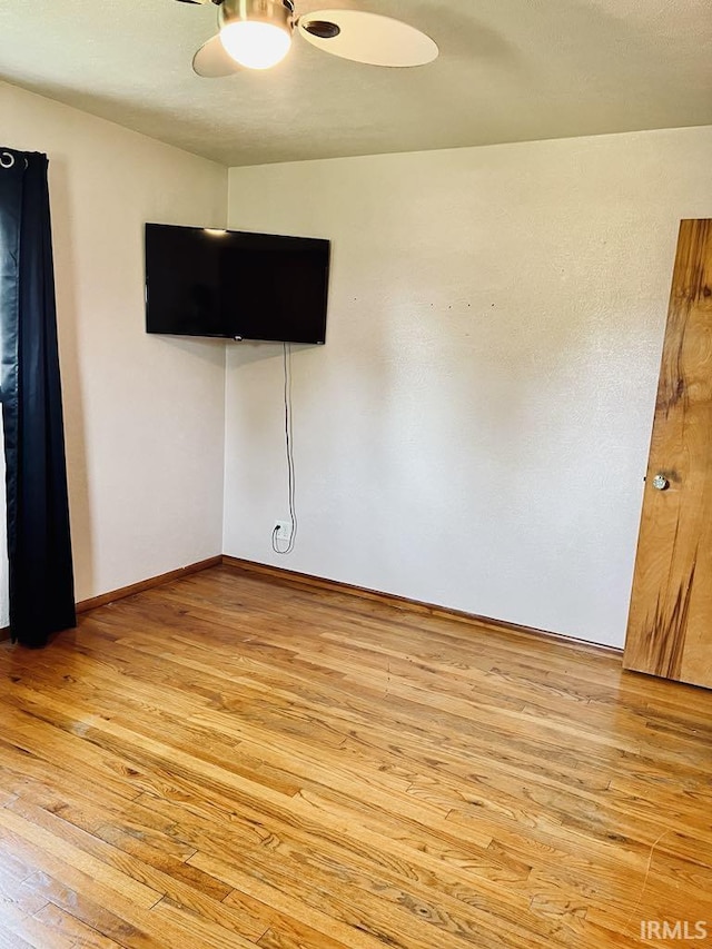 121 N Oakley Ave, Mishawaka, IN 46544 - unfurnished room featuring light wood-type flooring, a ceiling fan, and baseboards