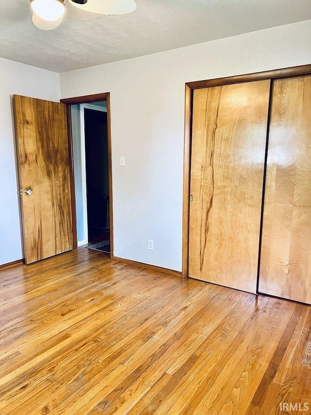 121 N Oakley Ave, Mishawaka, IN 46544 - unfurnished bedroom featuring light wood-type flooring, baseboards, and a closet