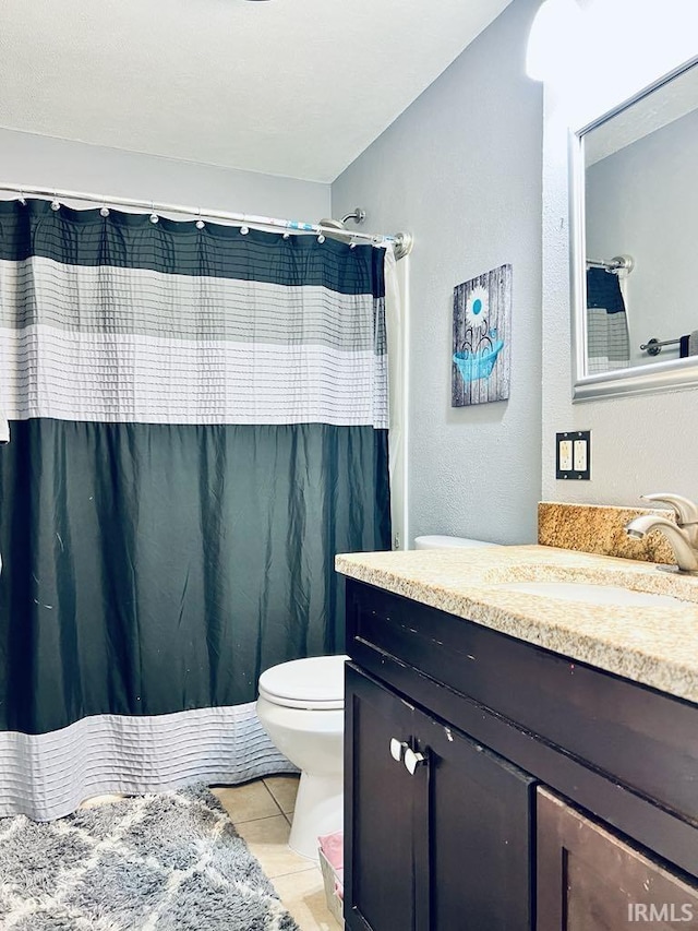 121 N Oakley Ave, Mishawaka, IN 46544 - full bathroom with toilet, vanity, tile patterned floors, a shower with shower curtain, and a textured wall