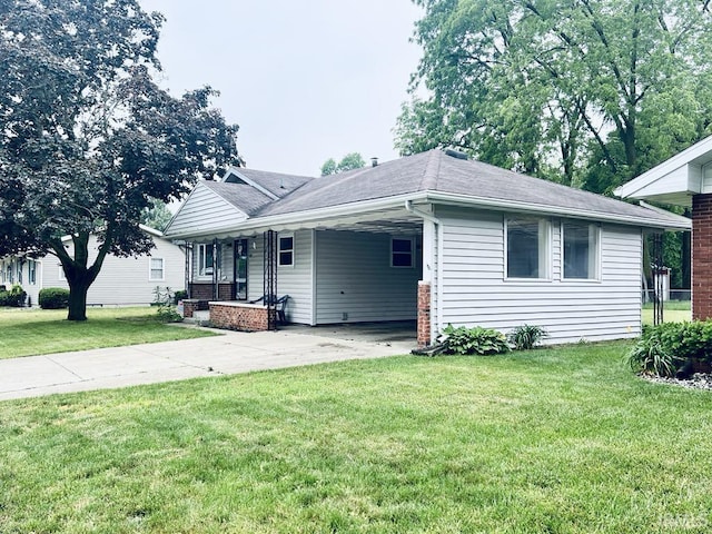 121 N Oakley Ave, Mishawaka, IN 46544 - view of front facade with concrete driveway, a front lawn, an attached carport, and a porch
