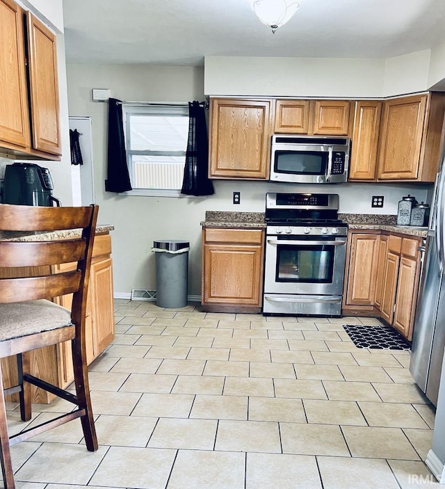 121 N Oakley Ave, Mishawaka, IN 46544 - kitchen featuring appliances with stainless steel finishes and brown cabinets