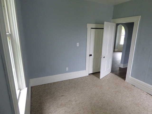 302 W Freeman St, Frankfort, IN 46041 - unfurnished bedroom with carpet, baseboards, a closet, and arched walkways