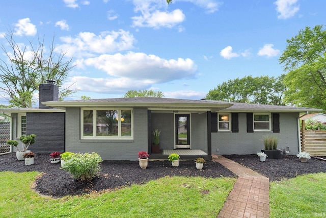 5012 Autumn Ln, Lafayette, IN 47909 - single story home featuring covered porch, brick siding, a chimney, and a front yard