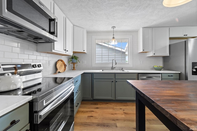 5012 Autumn Ln, Lafayette, IN 47909 - kitchen with stainless steel appliances, a sink, wooden counters, light wood-style flooring, and tasteful backsplash