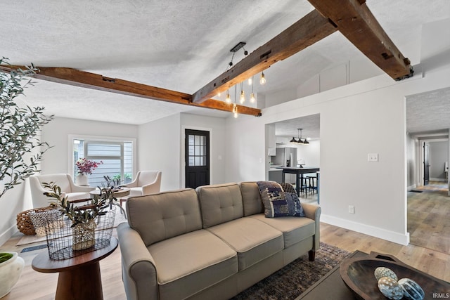 5012 Autumn Ln, Lafayette, IN 47909 - living area featuring baseboards, beamed ceiling, light wood-style floors, and a textured ceiling