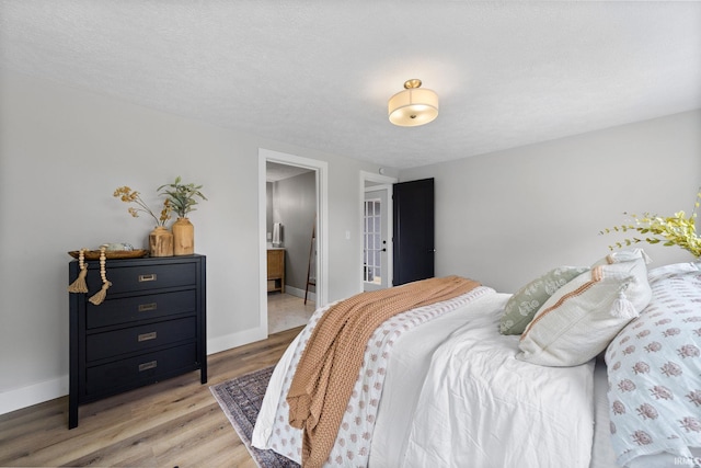 5012 Autumn Ln, Lafayette, IN 47909 - bedroom with french doors, light wood-style floors, baseboards, and connected bathroom