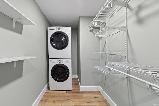 5012 Autumn Ln, Lafayette, IN 47909 - laundry room featuring stacked washer and clothes dryer, light wood-style flooring, and baseboards