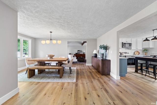 5012 Autumn Ln, Lafayette, IN 47909 - dining room featuring a textured ceiling, light wood-type flooring, and baseboards