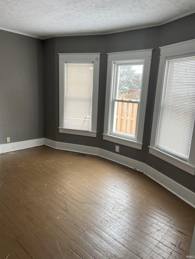 1118 N Webster St, Kokomo, IN 46901 - spare room featuring dark wood-style floors, a textured ceiling, and baseboards