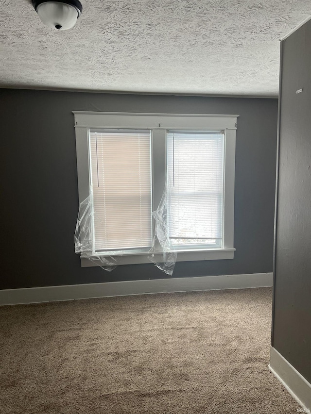 1118 N Webster St, Kokomo, IN 46901 - carpeted empty room with a textured ceiling and baseboards