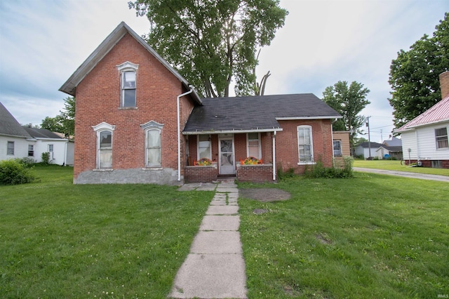 504 Mclean St, Ligonier, IN 46767 - traditional-style home with a front lawn, brick siding, and covered porch