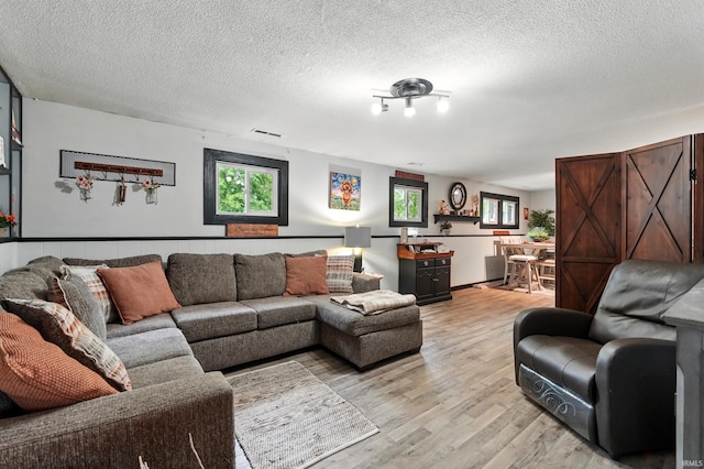 6916 Woodtrail Ct, Fort Wayne, IN 46835 - living area with light wood-style floors and a textured ceiling