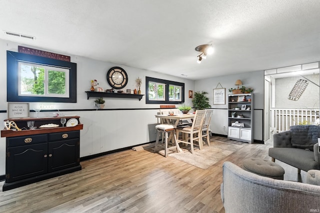 6916 Woodtrail Ct, Fort Wayne, IN 46835 - dining area with light wood-style floors and a textured ceiling