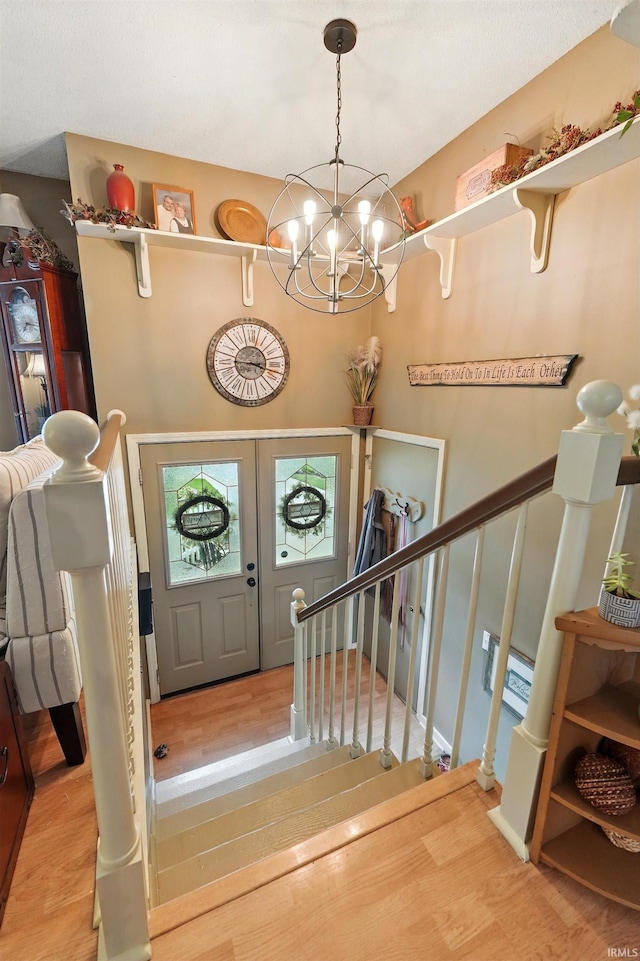 6916 Woodtrail Ct, Fort Wayne, IN 46835 - foyer featuring wood finished floors, a chandelier, and stairway