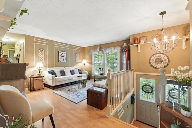 6916 Woodtrail Ct, Fort Wayne, IN 46835 - living room featuring a chandelier, wood finished floors, and a textured ceiling