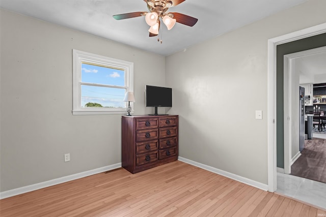 5345 E 00 Ns, Greentown, IN 46936 - unfurnished bedroom featuring hardwood / wood-style floors, baseboards, and a ceiling fan