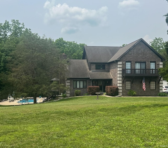 8288 S Mackenzie Ct, Bloomington, IN 47401 - view of front of property with brick siding, a front lawn, and an outdoor pool