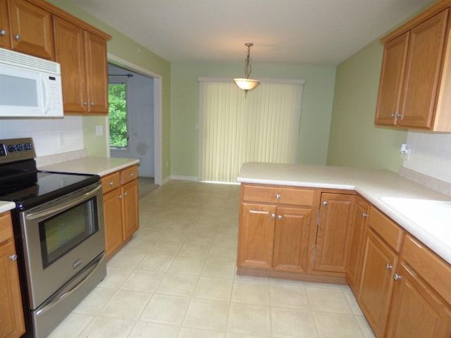 8202 Red Shank Ln, Fort Wayne, IN 46825 - kitchen with stainless steel range with electric cooktop, white microwave, a peninsula, tasteful backsplash, and light countertops