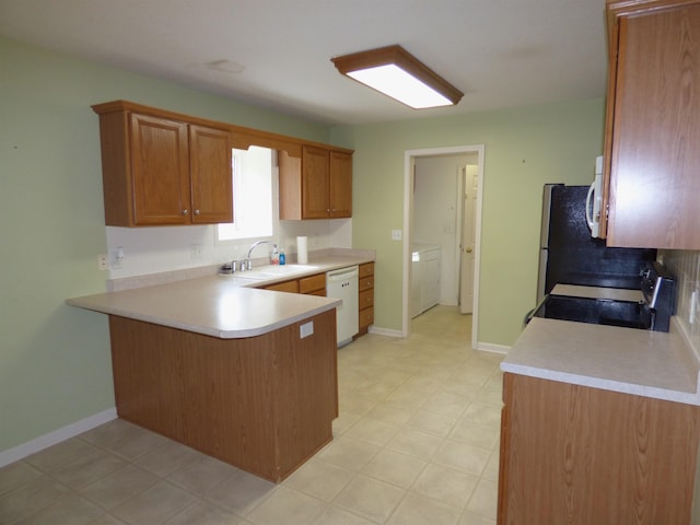 8202 Red Shank Ln, Fort Wayne, IN 46825 - kitchen featuring white appliances, a sink, a peninsula, light countertops, and brown cabinetry
